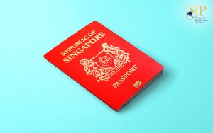 A Singapore Passport lying on a blue surface.